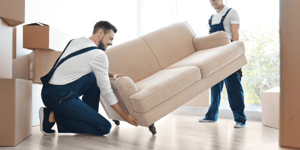 two movers lifting a couch