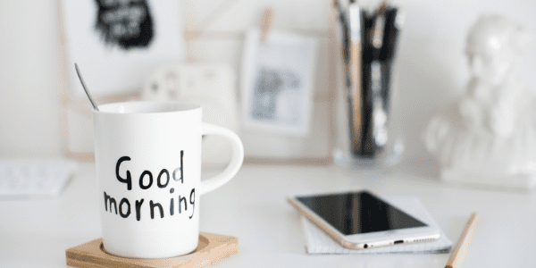 good morning mug and iphone on a desk