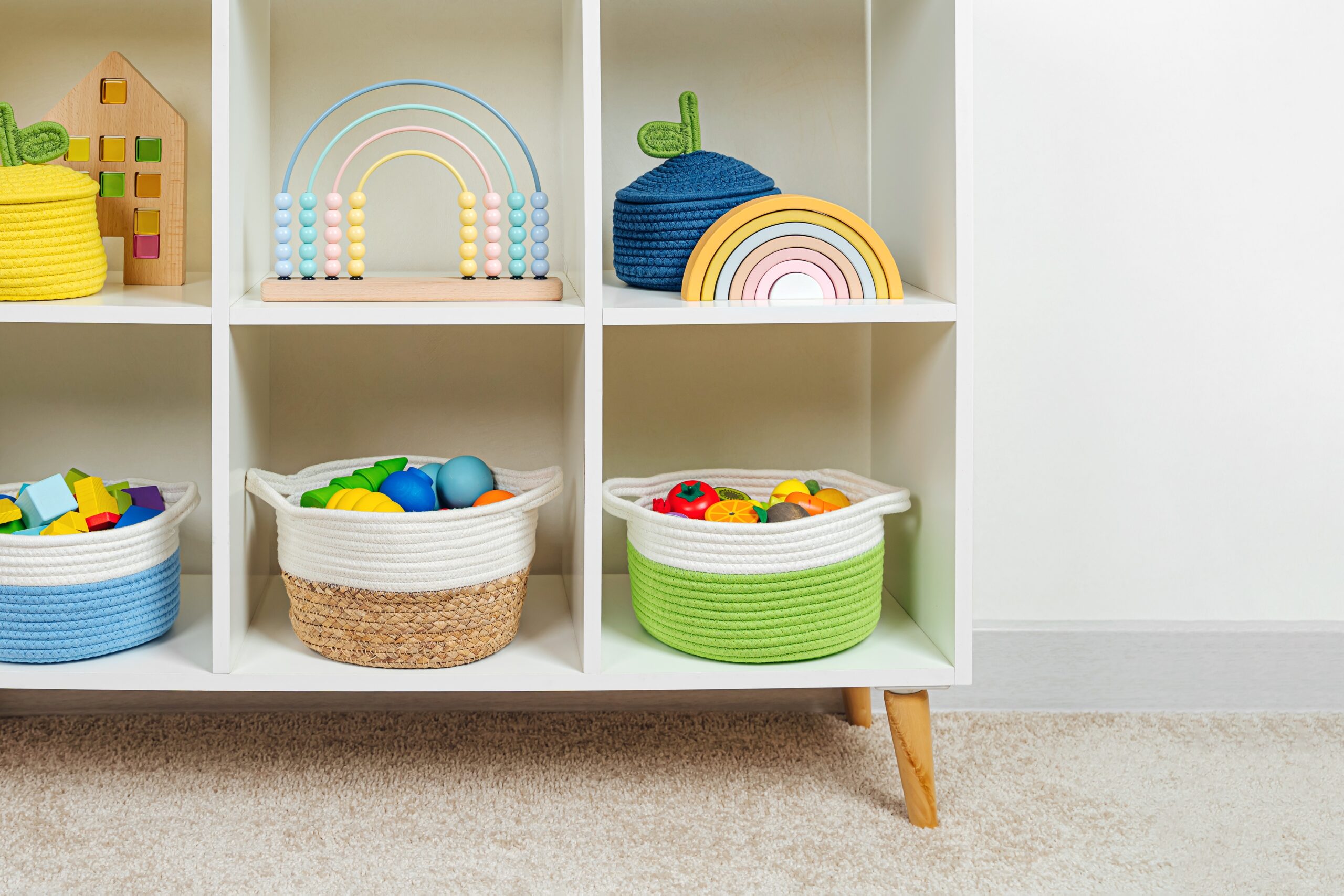 Colorful,Storage,Baskets,On,Shelves.,White,Shelving,With,Rainbow,Wooden Blog by Guardian Storage about toy rotation benefits: reduce clutter, boost creativity, and simplify cleanup at home