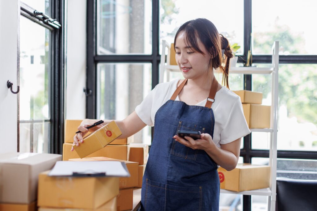 Small business owner organizing inventory boxes in a storage unit